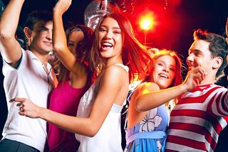 A group of young friends joyfully dancing together at a vibrant party on board a cruise ship | MSC Cruises