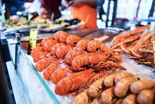 A vibrant seafood market display featuring fresh lobster and fish in Bergen, Norway | MSC Cruises
