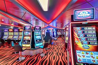 A vibrant interior of the Platinum Casino featuring slot machines and lively decor | MSC Cruises