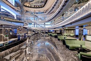 A spacious and inviting atrium featuring the Seaview Bar, with seating areas and elegant design elements | MSC Cruises