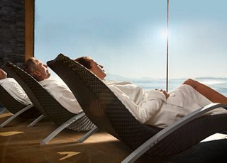 Guests enjoying a tranquil moment in the MSC Aurea Spa, surrounded by serene views and comfortable relaxation chairs | MSC Cruises