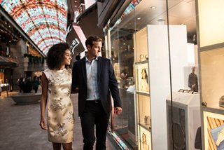 A couple enjoys window shopping together in the vibrant Galleria Meraviglia on MSC Meraviglia | MSC Cruises