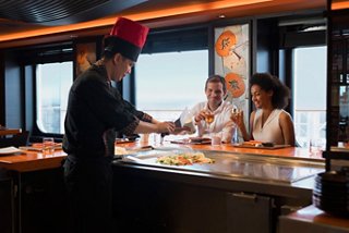 A chef serves a delicious dish to guests at the Teppanyaki restaurant on MSC Meraviglia | MSC Cruises