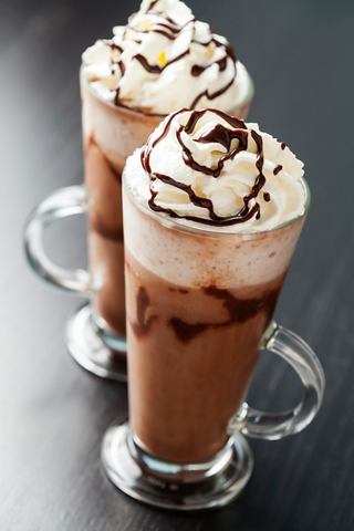Delicious coffee and chocolate dessert topped with whipped cream, served in elegant glasses | MSC Cruises