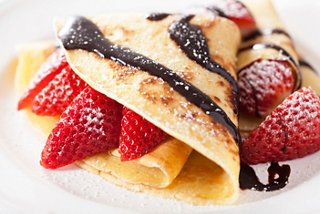Delicious crepes filled with strawberries and drizzled with chocolate sauce for a delightful dessert experience | MSC Cruises