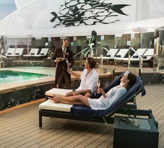 Guests relax by the pool in luxury loungers while enjoying attentive service on a cruise ship | MSC Cruises