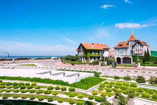 A scenic view of a coastal building surrounded by lush greenery in Montevideo, Uruguay | MSC Cruises