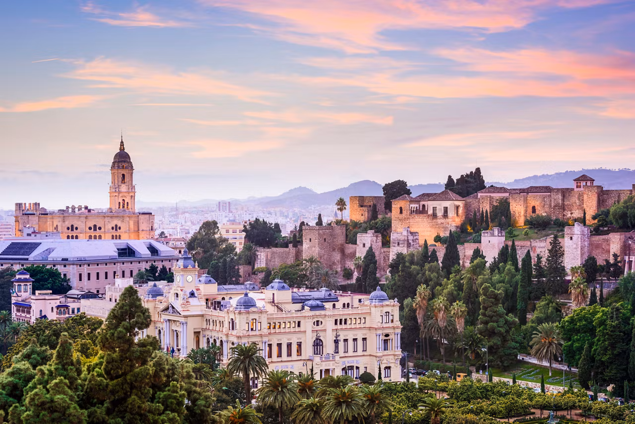 A panoramic view of Malaga showcasing the Cathedral, bell tower, and surrounding hills with lush vegetation | MSC Cruises