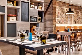 A stylish dining area featuring a table set for guests at the Hola! Tapas Bar by Ramon Freixa | MSC Cruises