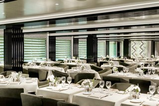 A spacious restaurant featuring elegantly arranged tables ready for guests onboard MSC Grandiosa | MSC Cruises