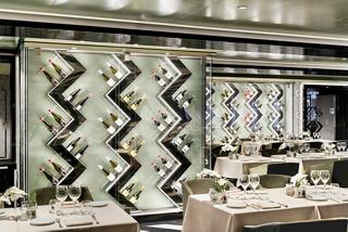 A stylish dining area featuring elegant decor, tables set for guests, and vibrant wall designs | MSC Cruises