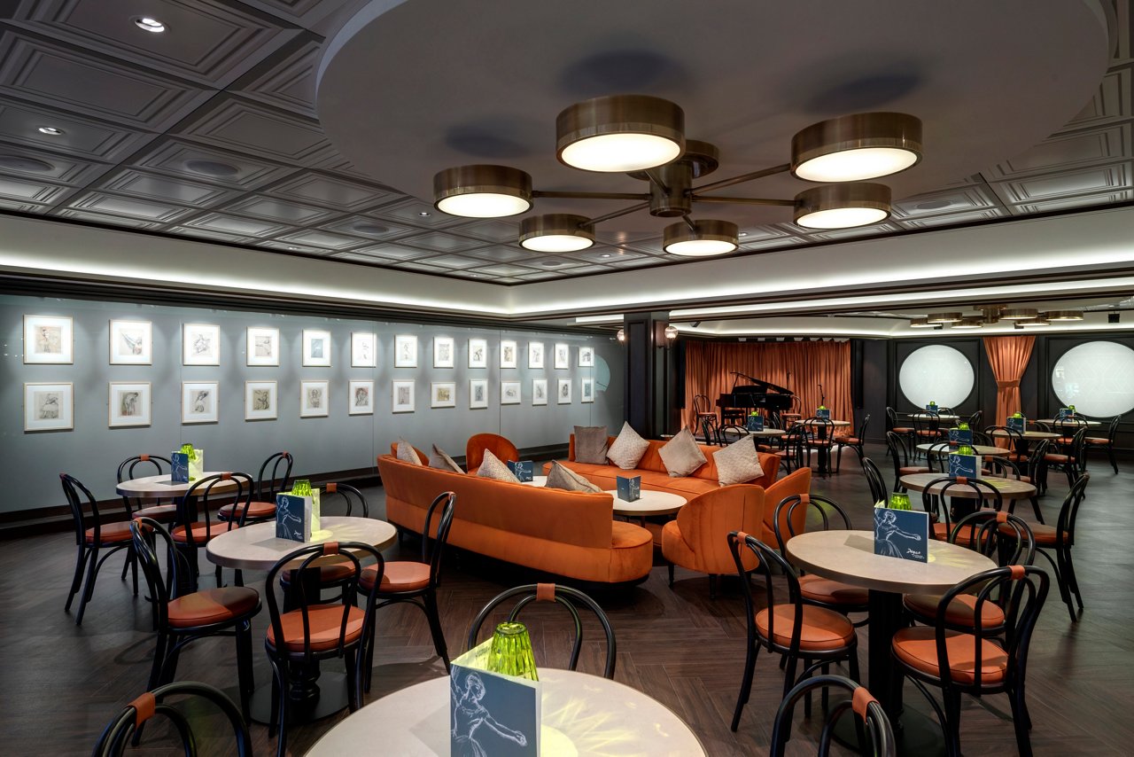 A stylish restaurant interior featuring a warm sitting area, tables, and artistic decor for a delightful dining experience | MSC Cruises