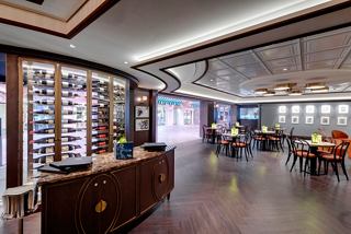 A welcoming atmosphere of the L'Atelier Bistrot restaurant entrance with elegant decor and seating arrangements | MSC Cruises