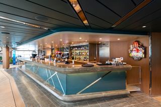 A stylish bar counter with a welcoming design, inviting guests to enjoy refreshments in a vibrant atmosphere | MSC Cruises