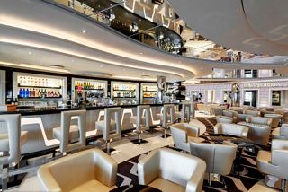 A spacious and elegantly designed bar and lounge area with comfortable seating and a welcoming atmosphere | MSC Cruises