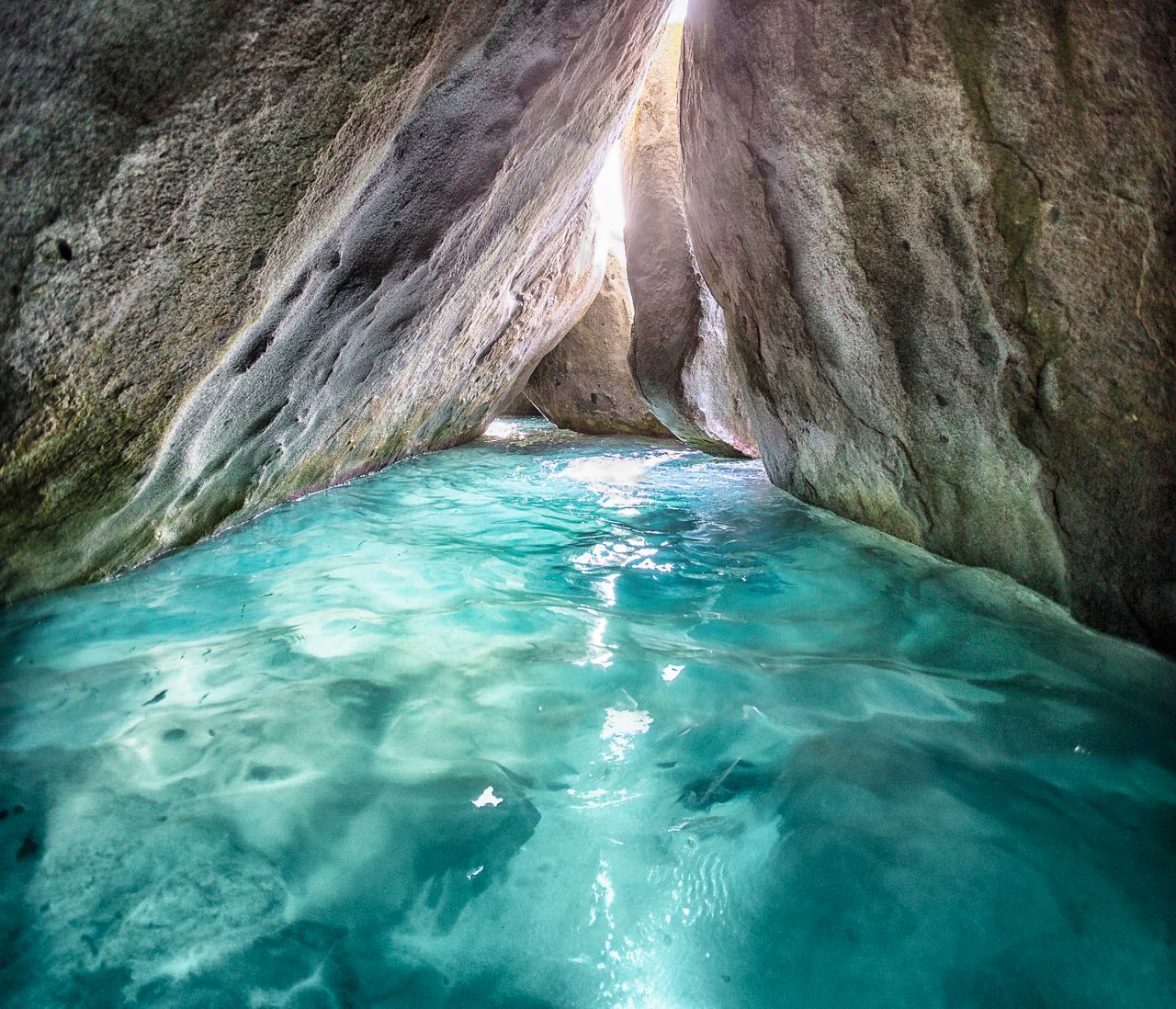 A serene view of turquoise waters surrounded by towering rocks, inviting exploration in Virgin Gorda | MSC Cruises