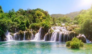 A stunning waterfall surrounded by lush greenery in Krka National Park, Croatia, inviting exploration and adventure | MSC Cruises