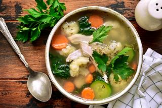 A vibrant bowl of chicken souse soup with vegetables and herbs, ready to be enjoyed | MSC Cruises