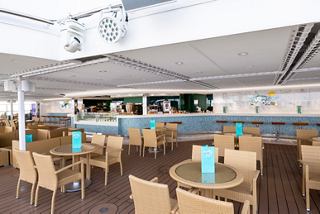 A vibrant outdoor bar area with stylish seating and a welcoming atmosphere for guests to relax and socialise | MSC Cruises