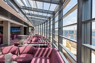 A bright and inviting seating area with large windows overlooking the sea | MSC Cruises