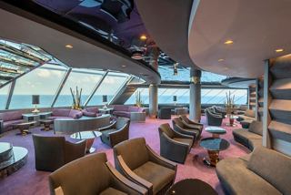 A spacious lounge area with panoramic sea views, featuring comfortable seating in the MSC Yacht Club | MSC Cruises