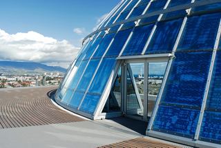 A stunning view of the Perlan museum's modern architecture in Reykjavik against a clear sky | MSC Cruises