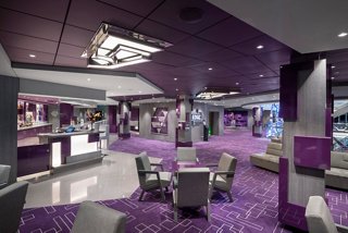 A stylish bar area on MSC Bellissima featuring comfortable seating and a vibrant atmosphere | MSC Cruises