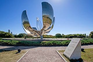 The iconic Floralis Genérica sculpture stands proudly in a vibrant park in Buenos Aires, surrounded by lush greenery | MSC Cruises