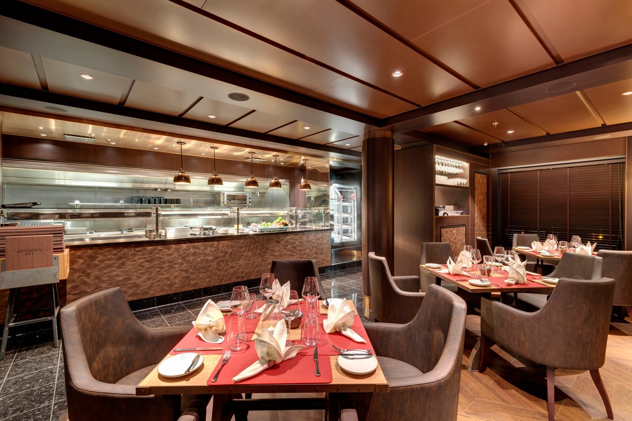 Elegant seating and warm lighting create an inviting atmosphere in the Butcher's Cut specialty restaurant aboard MSC Grandiosa | MSC Cruises