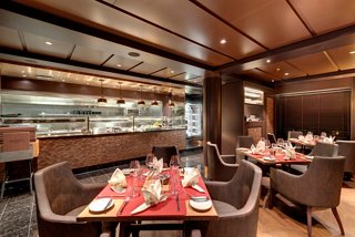 Elegant seating and warm lighting create an inviting atmosphere in the Butcher's Cut specialty restaurant aboard MSC Grandiosa | MSC Cruises