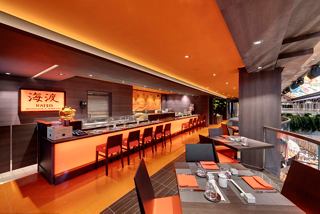 Kaito Sushi Bar features a modern interior with vibrant orange accents and inviting seating arrangements | MSC Cruises