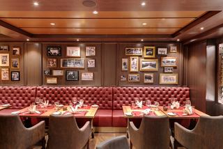 A stylish dining area with rich wooden accents and elegant seating invites guests to enjoy a memorable meal | MSC Cruises