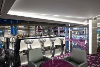 A stylish champagne bar featuring elegant seating and a modern counter for delightful social experiences | MSC Cruises