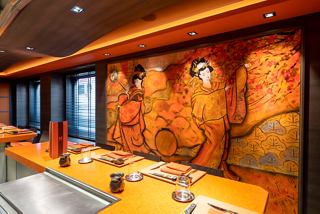 A vibrant interior of Kaito Teppanyaki restaurant featuring artistic wall decor and a welcoming dining area | MSC Cruises