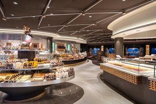 A spacious dessert area featuring an inviting layout with tables, pastries, and chocolate selections | MSC Cruises
