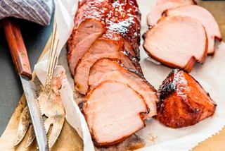 Succulent slices of roasted char siu pork served on a platter with a knife | MSC Cruises