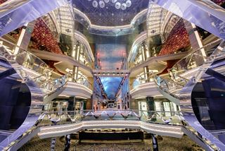 The stunning Infinity Atrium on MSC Grandiosa showcases an elegant design with vibrant decor and welcoming reception area | MSC Cruises