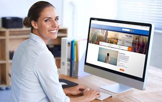A person engaging with a computer displaying the MSC Cruises website in a bright office setting | MSC Cruises
