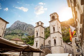 The sun sets behind the historic St Tryphon Cathedral and tower in Kotor, Montenegro, inviting exploration and wonder | MSC Cruises