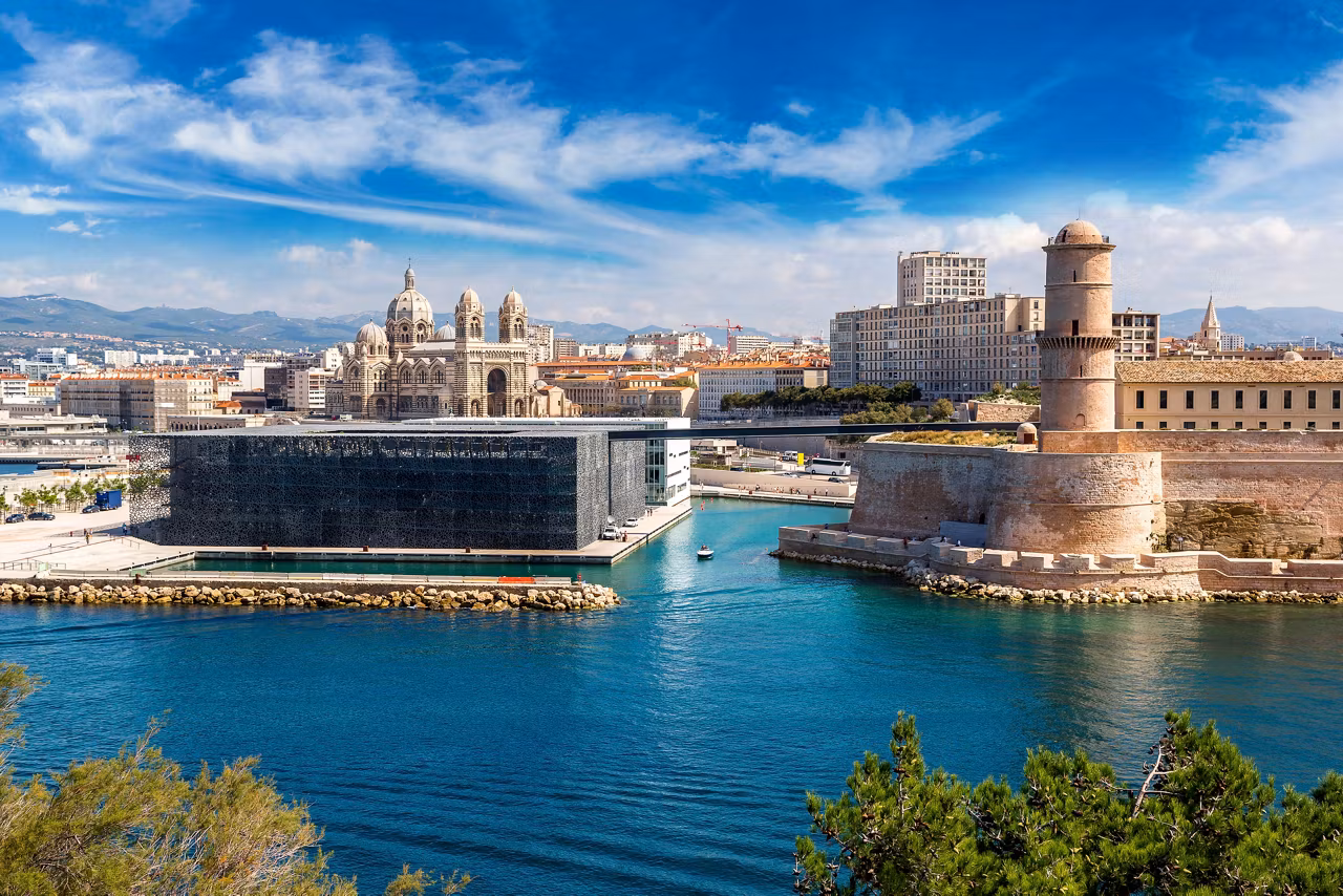 A stunning view of Marseille's port featuring majestic buildings and the sea, showcasing the city's rich heritage | MSC Cruises