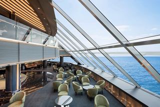 A stylish lounge area with panoramic sea views, offering comfortable seating for relaxation | MSC Cruises