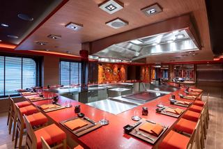 A warm and inviting interior of Kaito Teppanyaki restaurant featuring elegant seating and a modern cooking area | MSC Cruises