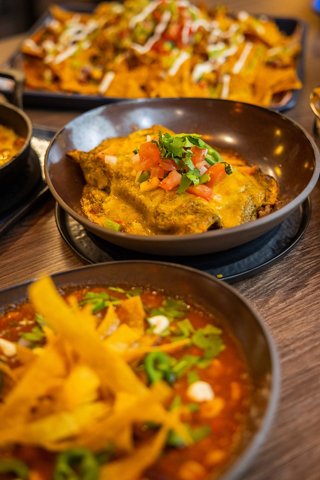 A selection of vibrant dishes served in bowls at the Hola! Tacos & Cantina restaurant onboard MSC Virtuosa | MSC Cruises