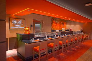 A vibrant interior view of the Kaito Sushi Bar featuring inviting seating and warm lighting | MSC Cruises