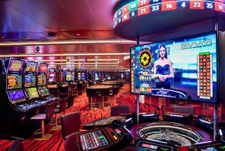 Guests enjoying gaming experiences at the vibrant Red Gem Casino aboard MSC Virtuosa | MSC Cruises