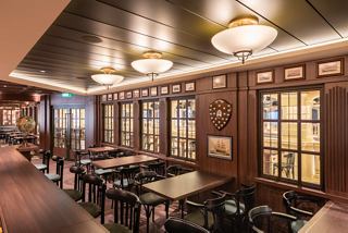 The inviting interior of the Masters of the Sea pub on MSC Virtuosa features warm lighting and elegant furnishings | MSC Cruises