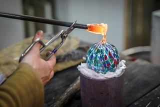 A skilled artisan shapes vibrant glass at a Murano factory, showcasing the artistry of Italian craftsmanship | MSC Cruises