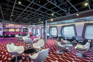 A stylish lounge area with modern seating and a bar, perfect for relaxation and entertainment on board | MSC Cruises