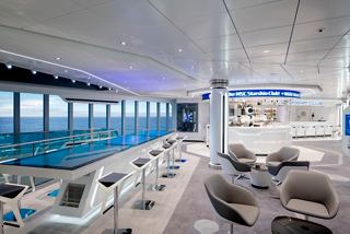 A stylish lounge area with panoramic sea views, featuring a futuristic atmosphere and innovative robotic service | MSC Cruises