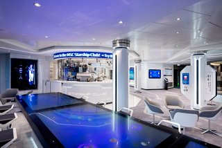 A modern bar area featuring an infinity table and stylish seating, inviting guests to relax and socialise | MSC Cruises